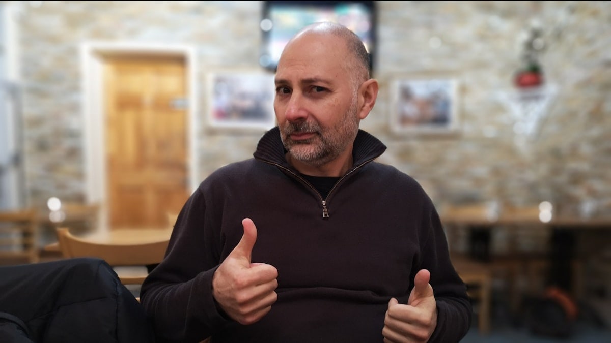 shallow focus photo of man in black quarter-zip jacket